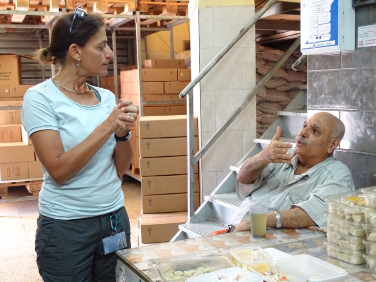 Visiting the tahini factory; Yael talks to the owner